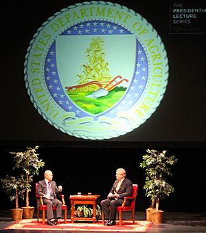 Purdue University President Mitch Daniels talks with Agriculture Secretary Tom Vilsack in 2014