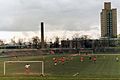 Older sports stadium, with football match in progress