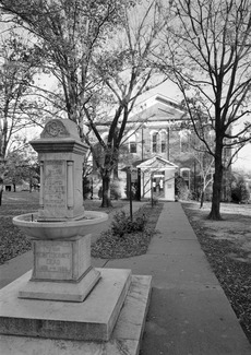 GENERAL VIEW OF FRONT ELEVATION WITH OBELISK MONUMENT IN FOREGROUND, FROM WEST - Cherokee National Capitol Building, 101-29 South Muskogee Avenue, Tahlequah, Cherokee County, OK HABS OKLA,11-TAHL,2-2