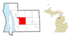 Location within Antrim County (red) and an administered portion of the Bellaire village (pink)