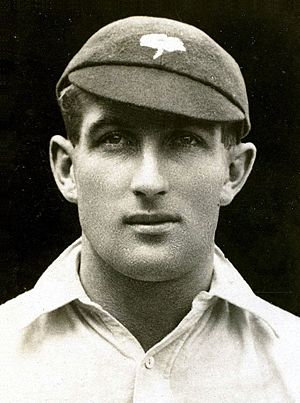 A headshot of a cricketer in a cap