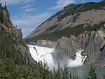 Waterfalls on a river, surrounded by granite peaks