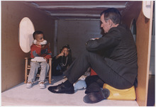 President Bush plays with children in a jungle gym at the Emily Harris Head Start Center in Catonsville, Maryland... - NARA - 186444