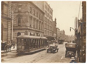 (Looking north along George Street (with tram, T-model Ford and hansom cab) from Union Line Building (incorporating the Bjelke-Petersen School of Physical culture), corner Jamieson Street), n.d. by (5955844045)
