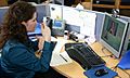 Deaf or HoH person at her workplace using a Video Relay Service to communicate with a hearing person via a video interpreter and sign language IMG 2954