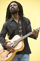 Rocky Dawuni playing the guitar