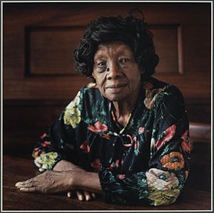 Portrait of Minnie L. Fisher sitting at a table