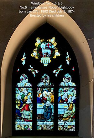 Stained glass window where the middle panel commemorates Robert Lightbody