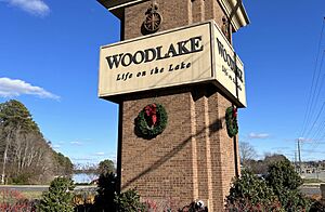 Entrance sign for Woodlake, with the Swift Creek Reservoir behind it.