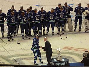 Henrik Sedin accepts the trophy