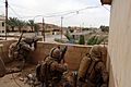 US Navy 060520-N-7497P-229 Cpl. Julius Mitchell, left, and Cpl. Jeremy Rugg, center, lay down covering fire while Cpl. Adam Gokey spots insurgent positions on his right and fires a grenade, seen traveling through the air, whil