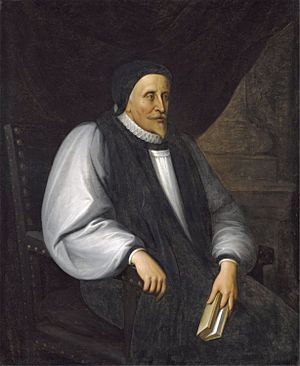 A solemn old white man clothed in Reformation-era clerical robes, seated and holding a book