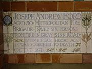 A tablet formed of five tiles of varying sizes, bordered by yellow and blue flowers in an art nouveau style