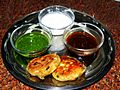 Aloo Tikki served with chutneys.jpg