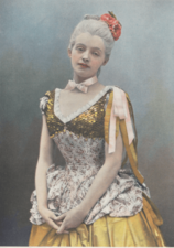 Young white woman in white powdered wig and 18th century costume