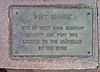 A metallic plaque with the words "Fort Orange: Site of West India Company Colony 1624, was located to the southeast by the river."