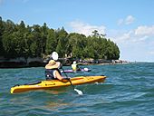 The sea caves (left in the picture) at Cave Point County Park are mostly inaccessible except by boat, although there is better access by foot during years with low lake levels.