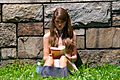 Cute girl reading outdoors