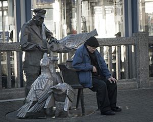 Man by a Statue