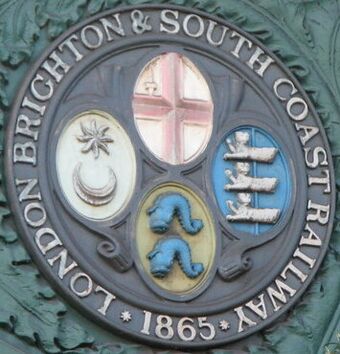 Plaque on the (western) railway bridge over Battersea Park Road, SW8 (cropped).jpg