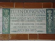 A tablet formed of six standard sized tiles, bordered by green flowers in the style of the Arts and Crafts movement