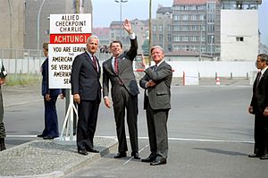 President Ronald Reagan waves and stands with Chancellor Helmut Schmidt and Berlin Mayor Richard von Weizsacker