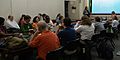 People sitting around a long table with laptop computers