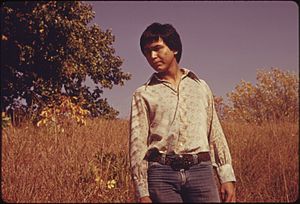 RON MCKINNEY, 22, WHOSE INDIAN NAME IS MAHKUK, IS STANDING IN A VIRGIN TALLGRASS PRAIRIE AREA NEAR WHITE CLOUD AND... - NARA - 557112.jpg