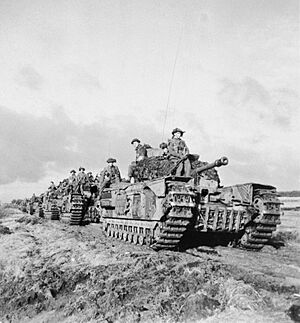 Churchill tanks of 3rd Scots Guards, 6th Guards Tank Brigade, with infantry of 2nd Argyll and Sutherland Highlanders, advance near Beringe in Holland, 22 November 1944. B12026