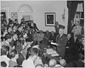 Photograph of President Truman in the Oval Office, reading the announcement of Japan's surrender to assembled... - NARA - 199171