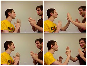 Two young men playing pat-a-cake