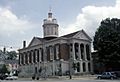 Red courthouse with white columns and a tall cupola