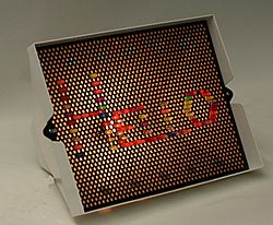 A Lite-Brite (without black paper) spelling "Hello"