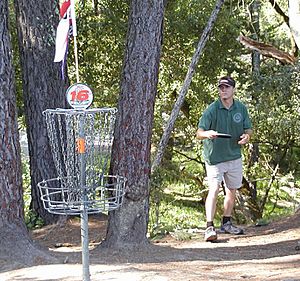 Disc golfer and basket.jpg