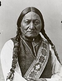 Black-and-white photo of Sitting Bull, looking straight into the camera