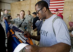 Von Miller signing autographs at Transit Center Manas-March 2013