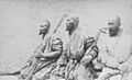 Photo of three bearded, armed men