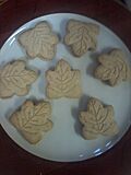 Seven maple leaf cookies on a plate.jpg