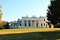 Photograph of the Gaineswood house across a lawn on a sunny day.