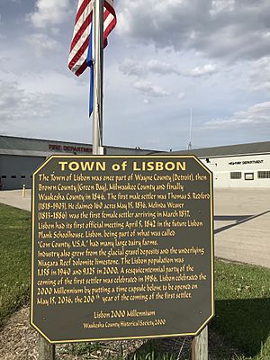 Historical sign outside the fire and highway departments detailing Lisbon village history