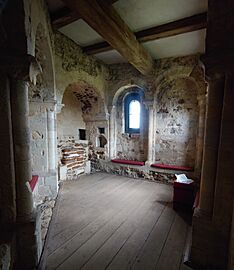 A small, irregularly shaped room with a window and a recess for an altar.