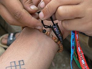 Tying friendship bracelet