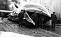 Group of men standing with dead whale, American Pacific Sea Products Co, Akutan Harbor, Alaska, 1914 (COBB 43)