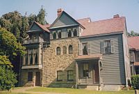 A large three-story house of wood and stone