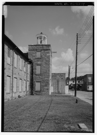 DETAIL VIEW OF SOUTH SIDE OF NORTH STAIR TOWER. GRANITE STRUCTURE IN BACKGROUND IS THE 'PICKER HOUSE' AREA EXPANDED IN THE 1940s. - Graniteville Mill, Marshall Street, Graniteville HAER SC,2-GRANV,1-4.tif